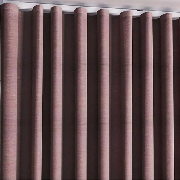A close-up shot of a wave fold blackout curtain in a solid, muted reddish-brown or mauve color.