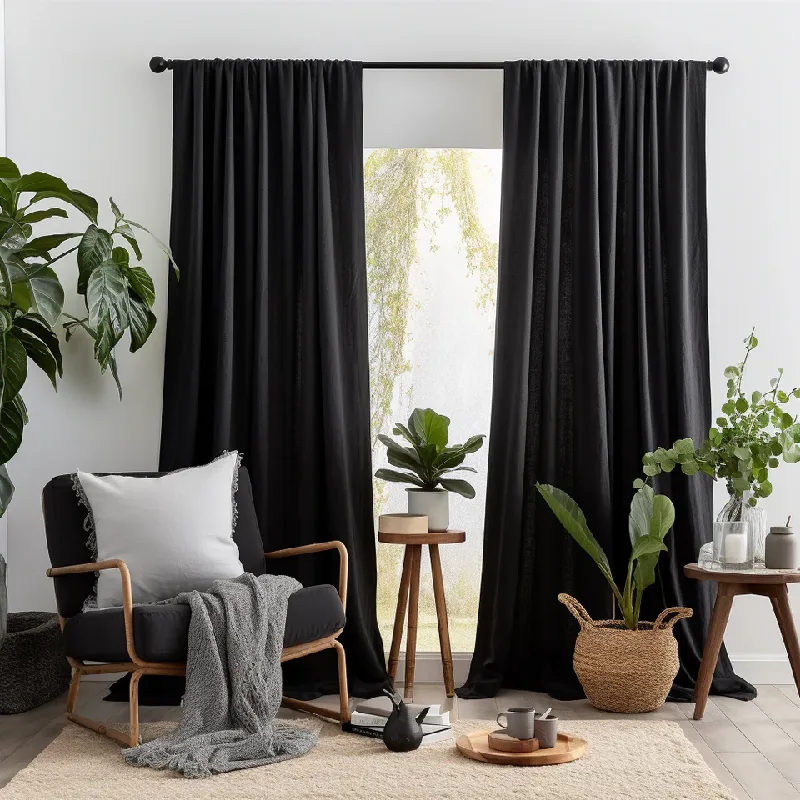 Black soundproof curtains framing a bright window.