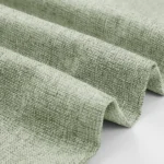 Close-up of light green linen-look fabric texture.