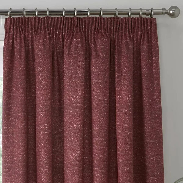 Close-up of pink textured pencil pleat curtain.