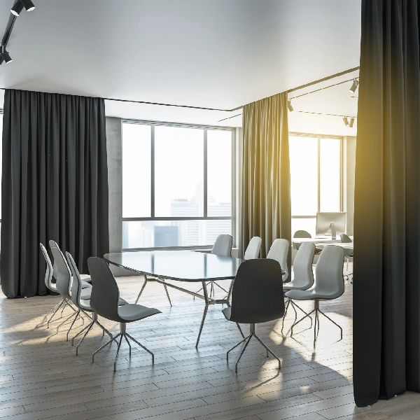 Dark soundproof curtains in sunlit modern conference room.