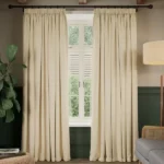 Light beige soundproof curtains framing a window.