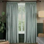 Light sage soundproof curtains framing a window.