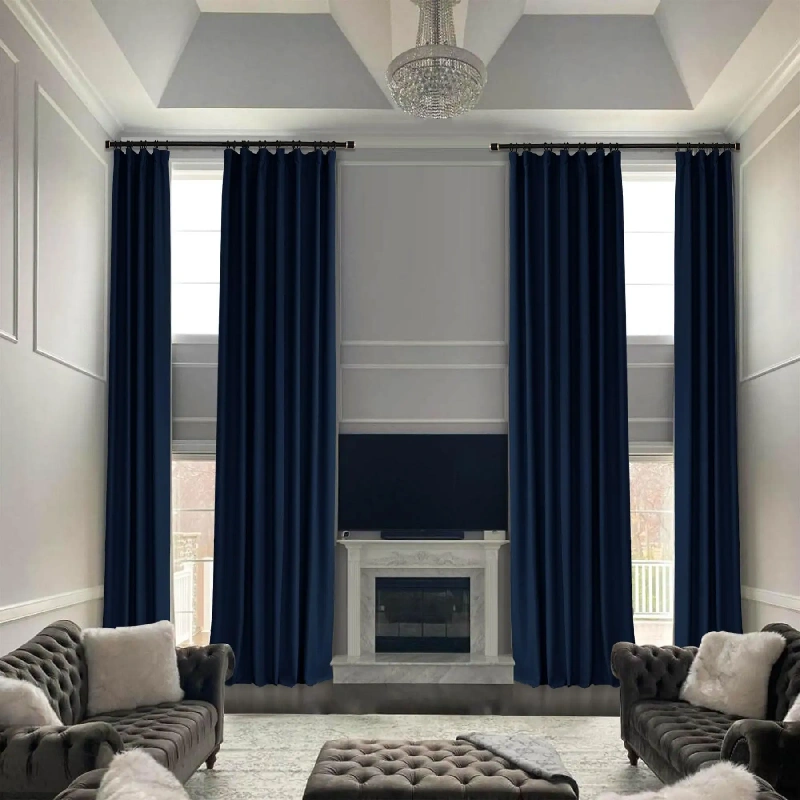 Navy blue soundproof curtains framing windows and fireplace.