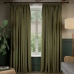 Olive green soundproof curtains framing a window.