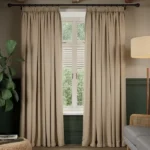 Taupe soundproof curtains framing a window.