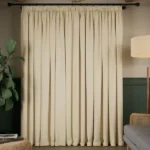light beige soundproof curtain covering a window.