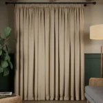 taupe soundproof curtain covering a window.